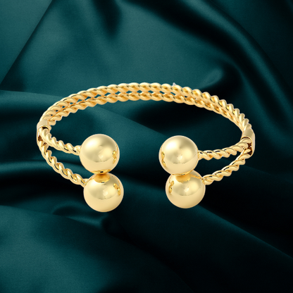 Linked set of two 18k gold plated Belizean Harmony bangles.