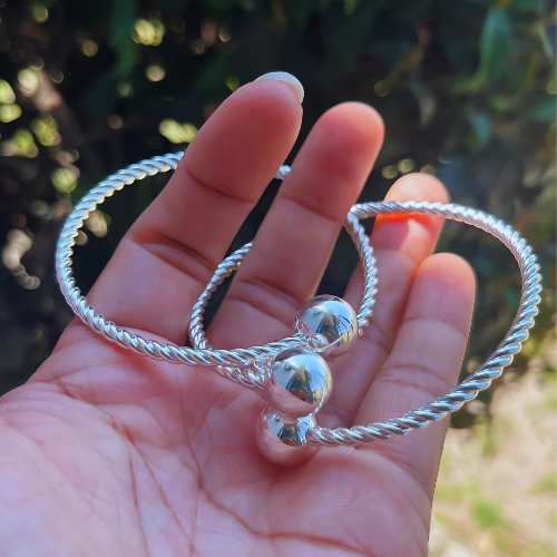 Close-up of the rhodium-plated Belizean Harmony Loops Bangles.
